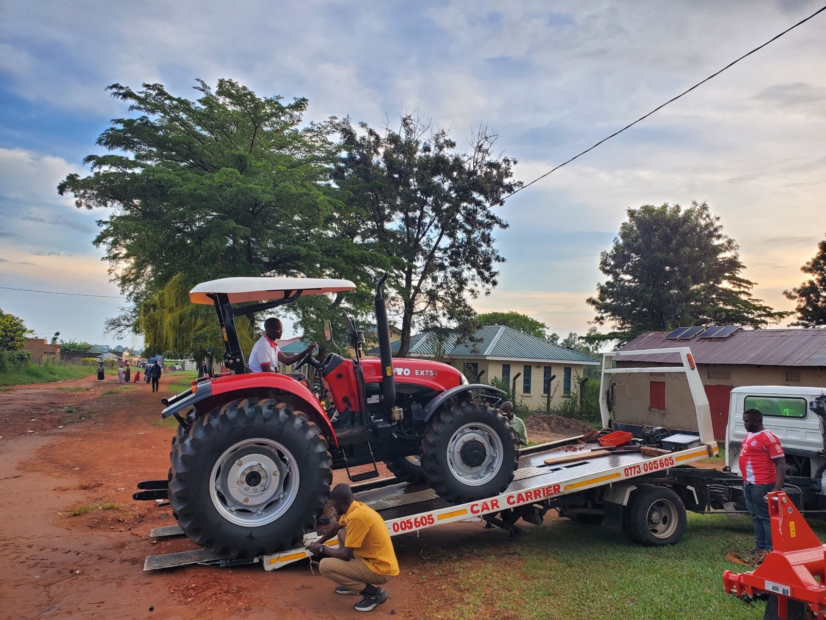 A YTO EX754 being offloaded from a car carrier at the trading centre